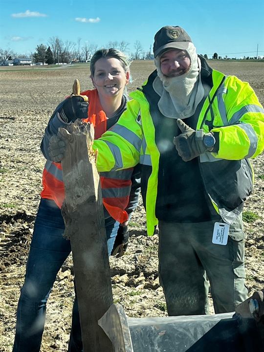 Two volunteers show a find during tornado cleanup in Springfield, Ohio