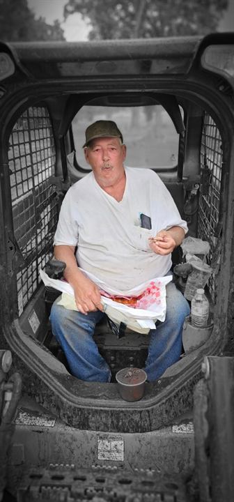 A volunteer runs a skid steer in Springfield, Ohio