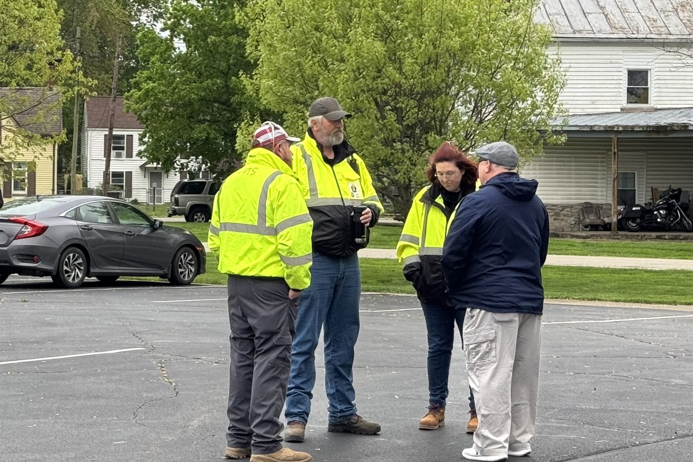 Team members in high-visibility vests plan at a deployment briefing